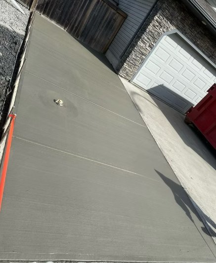 Finished concrete driveway beside a garage