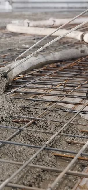 Rebar grid being covered by a concrete pour
